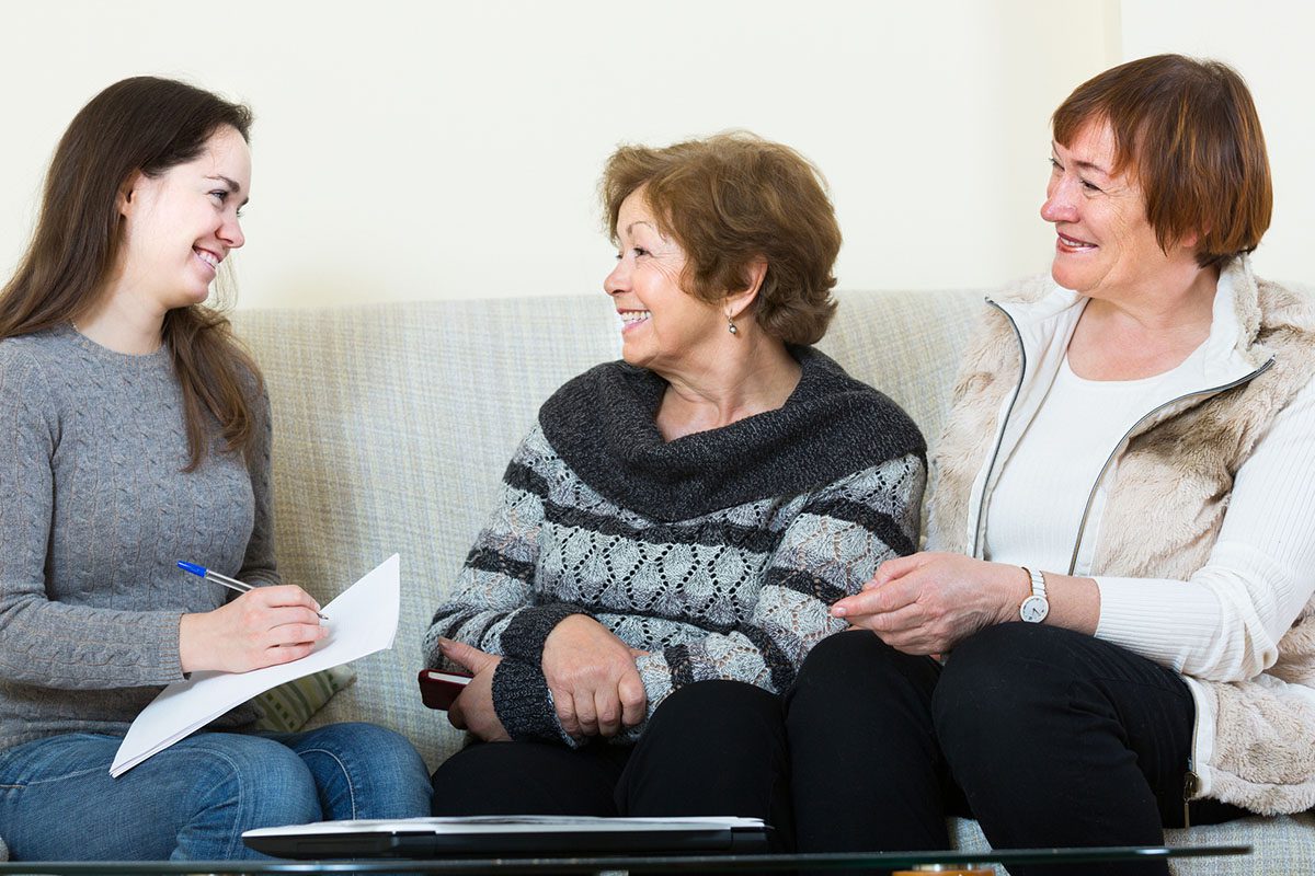 Three women sitting on a couch