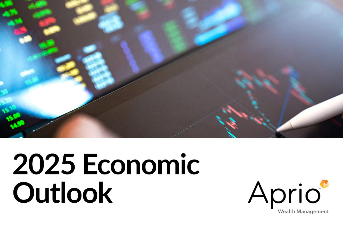 A digital display shows financial charts and stock data above the text 2025 Economic Outlook and the Aprio Wealth Management logo.