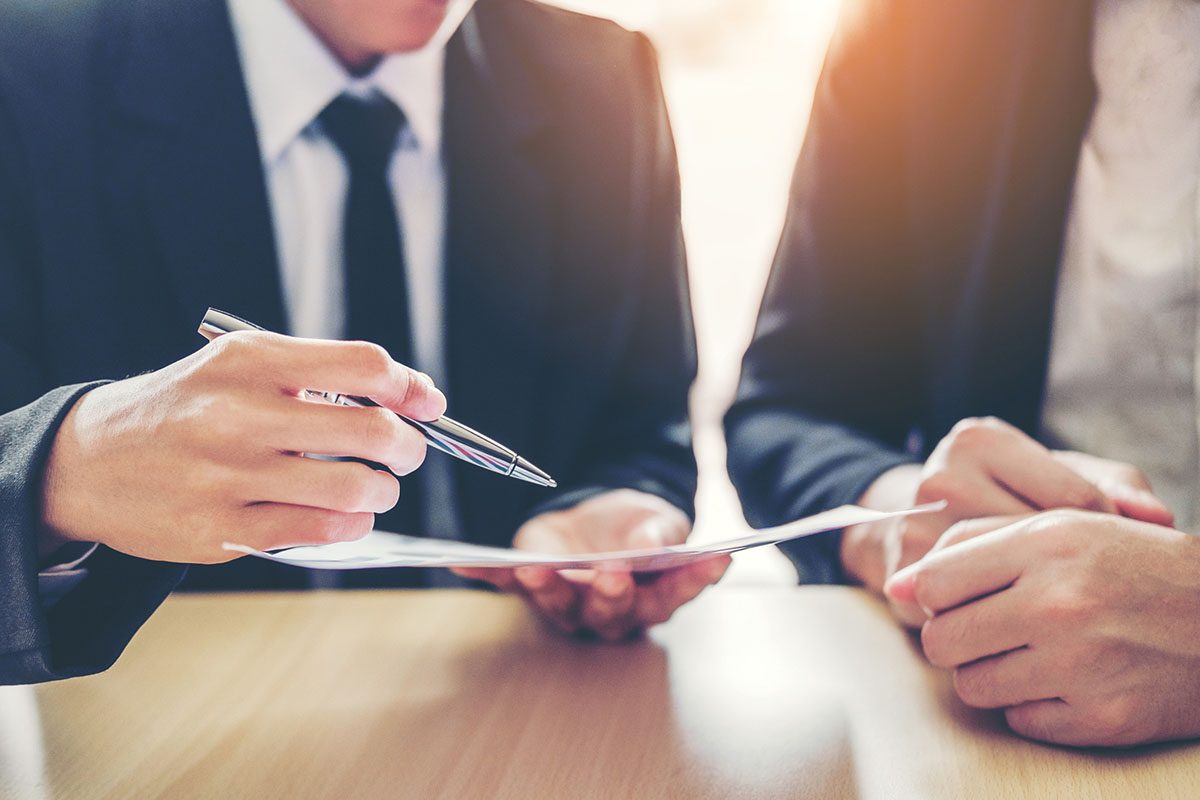 Two people in business attire sit at a table