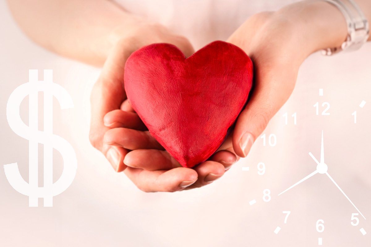 A person holds a red heart shape in their hands