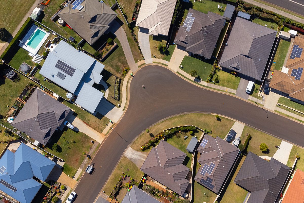 Aerial view of a suburban neighborhood showing several houses with driveways